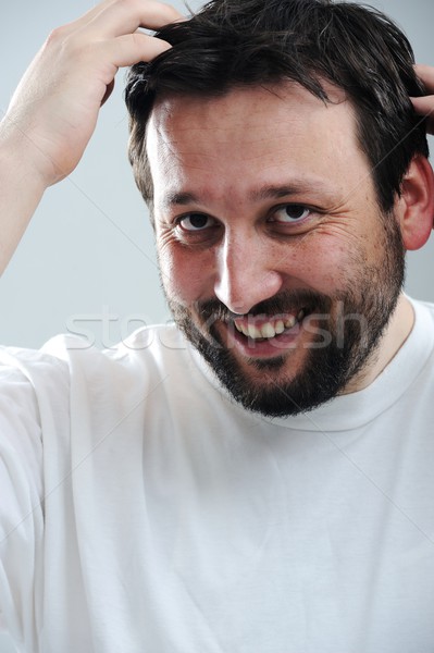 Portrait of young man smiling Stock photo © zurijeta