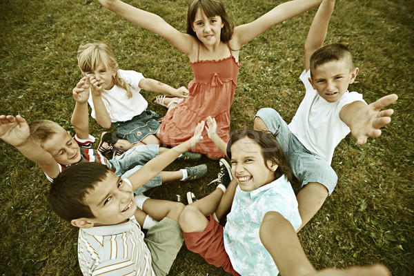 Vintage photo of a group of happy children on summer grass meado Stock photo © zurijeta