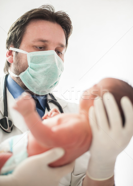 Pediatrician holding a newborn baby boy in hospital Stock photo © zurijeta