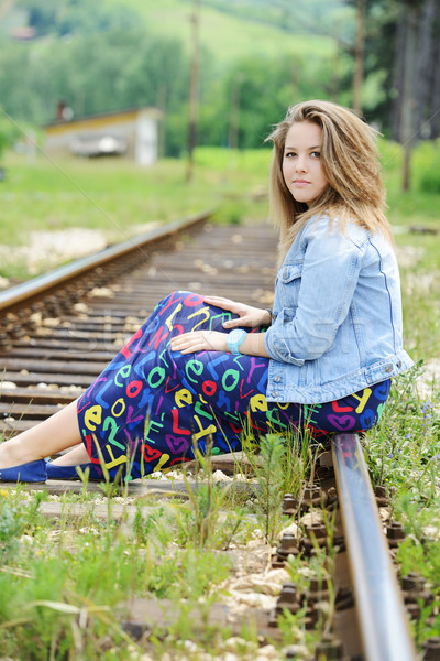 Woman sitting on railway tracks Stock photo © zurijeta