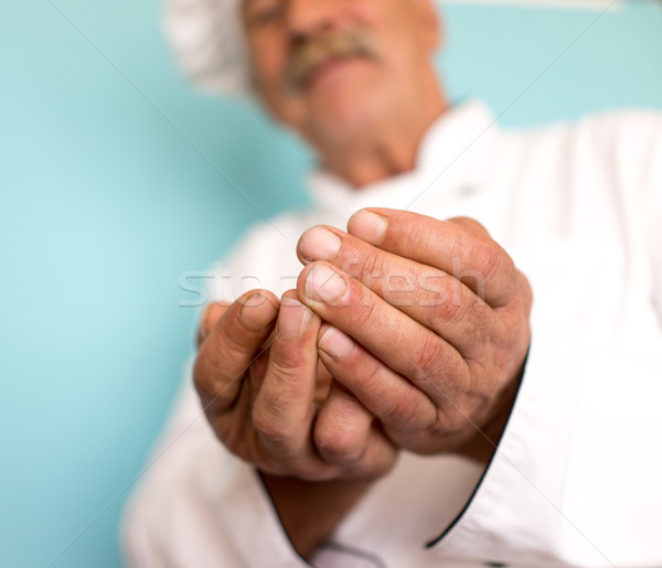 Senior cook with mustache holding in hands Stock photo © zurijeta