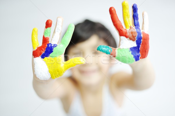 Stock photo: Little boy with hands painted in colorful paints ready for hand 
