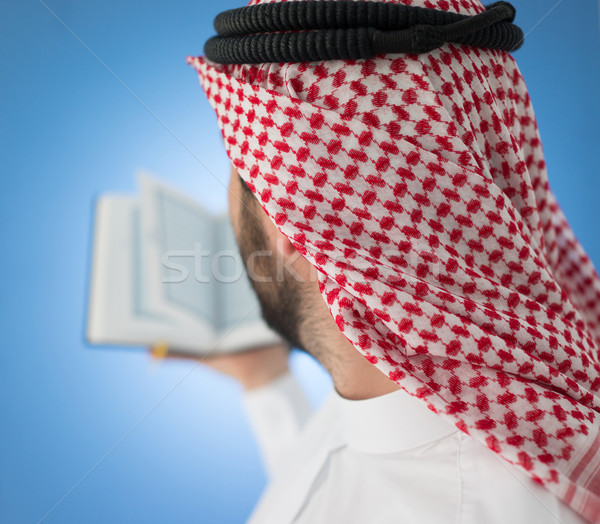 Arabic man praying with Koran Stock photo © zurijeta