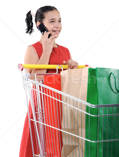 Little girl shopper in red dress with shopping cart Stock photo © zurijeta