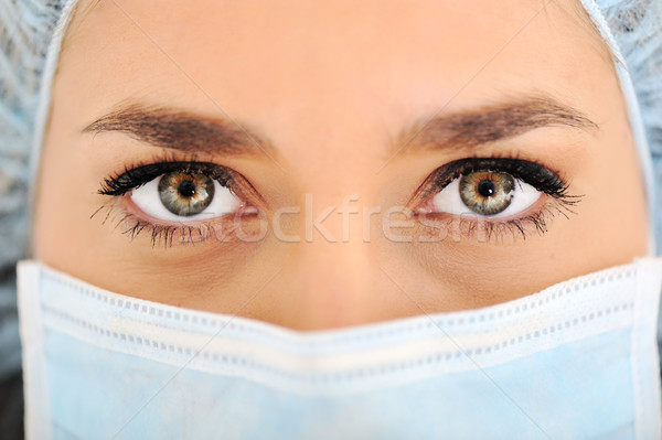 Female doctor wearing surgical cap and mask Stock photo © zurijeta