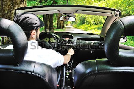 Young guy driving a sports car in forest Stock photo © zurijeta