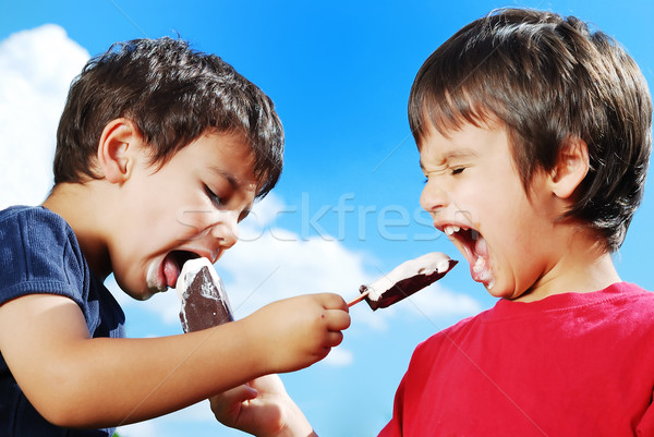 Two kids feeding each other ice cream Stock photo © zurijeta