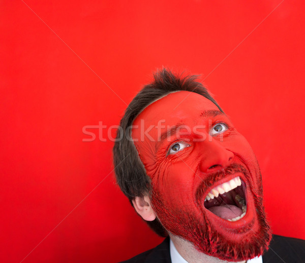 Stock photo: Young man portait with red painted face and copy space