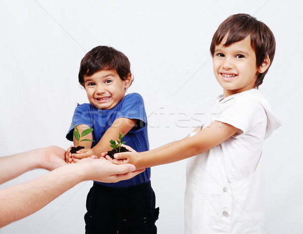 Stock photo: Save our earth, two boys with plant in hands