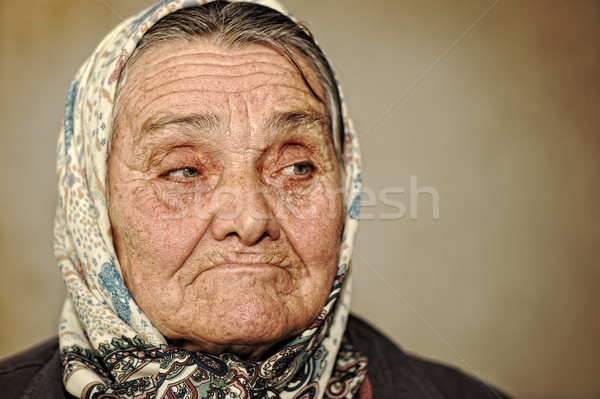 Portrait of mature woman with green eyes and scarf on head looking aside Stock photo © zurijeta