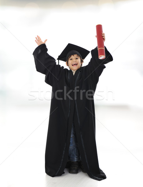 Happy successful kid with diploma and graduating clothes Stock photo © zurijeta