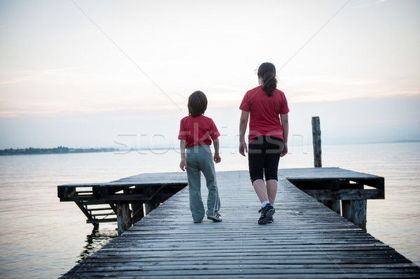 Girld and boy on lake dock in Italy Stock photo © zurijeta