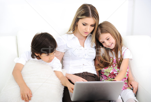 Mother with daugther and son using  laptop on sofa Stock photo © zurijeta