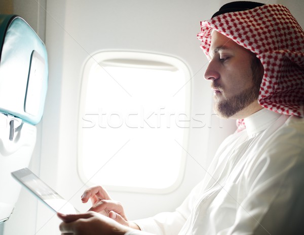 Modern Arabic businessman inside airplane Stock photo © zurijeta