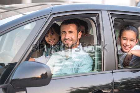 Smiling family in car Stock photo © zurijeta