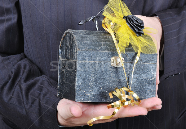 Nice gift chest in hands of businessman in suite Stock photo © zurijeta