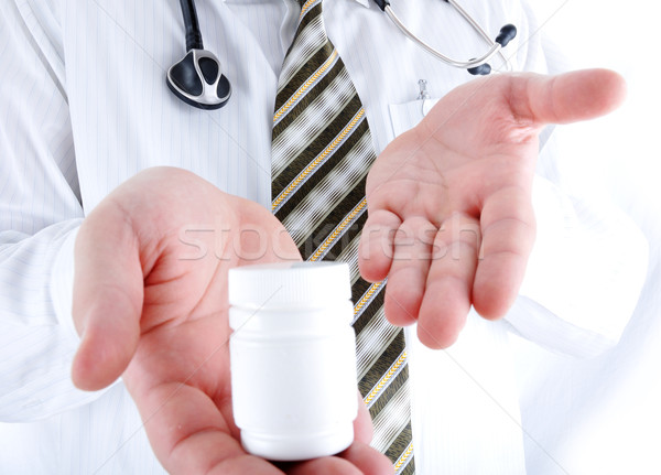 Closeup, doctor holding little pills bottle - copy space for you Stock photo © zurijeta