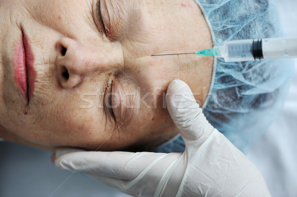 Senior woman getting on face injection at hospital Stock photo © zurijeta