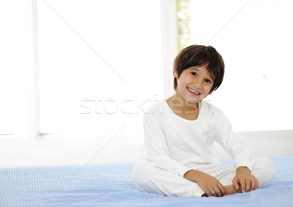 Kid on sleeping bed, happy bedtime in white bedroom Stock photo © zurijeta