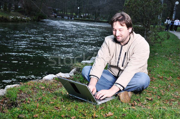 Young man with laptop outdoor Stock photo © zurijeta