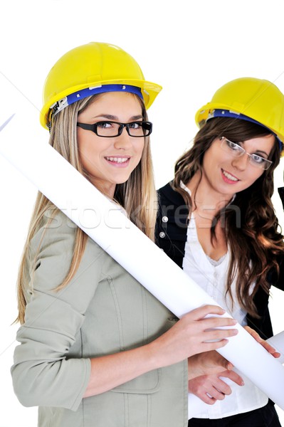 Young architects wearing a protective helmet and holding bluepri Stock photo © zurijeta