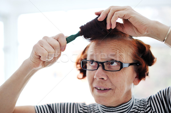 Senior lady hair comb Stock photo © zurijeta