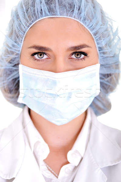 Female doctor wearing surgical cap and mask Stock photo © zurijeta