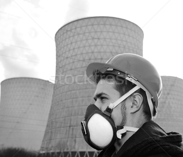 Engineer with protective helmet standing in front of nuclear pow Stock photo © zurijeta