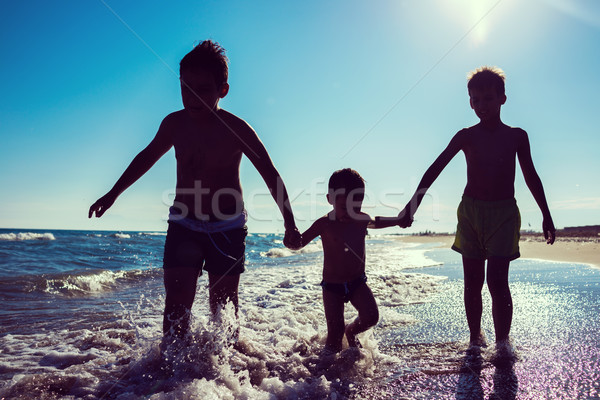 Fun kids playing splash at beach Stock photo © zurijeta