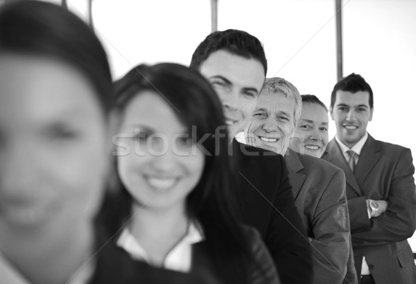 Six cheerful business people standing in a row with their arms f Stock photo © zurijeta