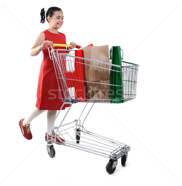 Little girl shopper in red dress with shopping cart Stock photo © zurijeta