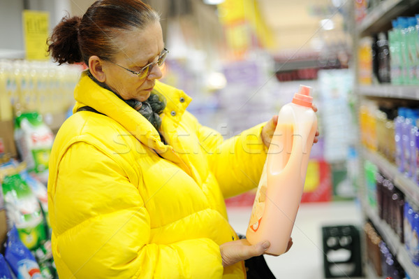 Elderly woman buying shampoo Stock photo © zurijeta