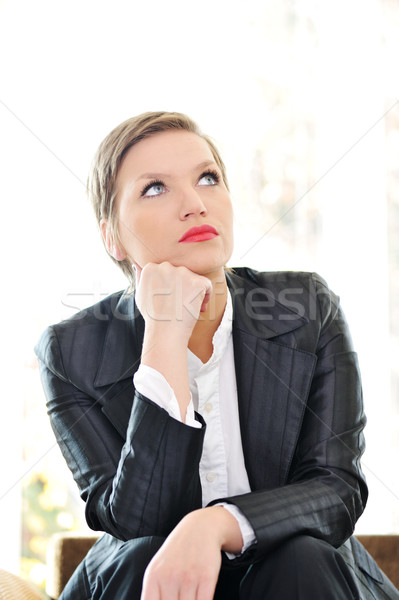 Young business woman sitting at office and thinking Stock photo © zurijeta