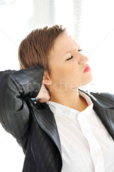 Young business woman suffering from severe neck pain Stock photo © zurijeta