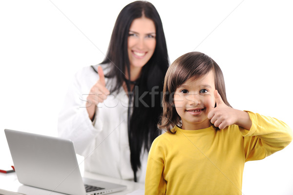 Young female doctor examining little cute happy child with thumb up, good experience at hospital Stock photo © zurijeta