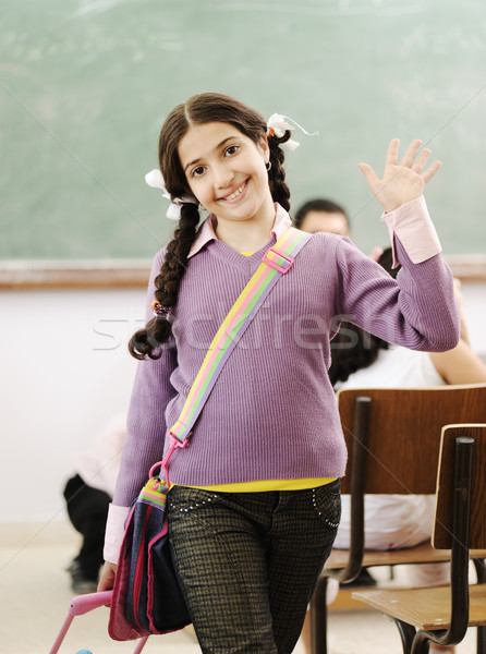 Stock photo: Cute little girl at school saying hello