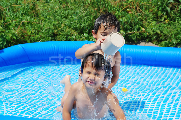 Children activities on swiming pool in summer Stock photo © zurijeta
