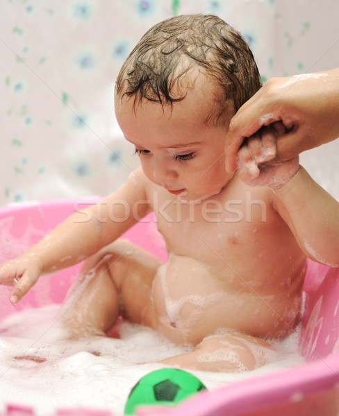 Stock photo: Adorable baby boy taking a bath with soap suds on hair