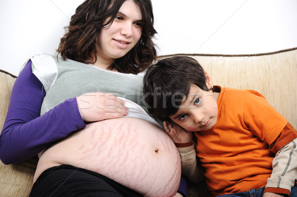 Stock photo: A little boy and his pregnant mother spend time together