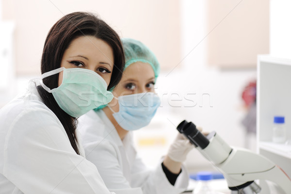 Two scientists working at the laboratory with microscope Stock photo © zurijeta