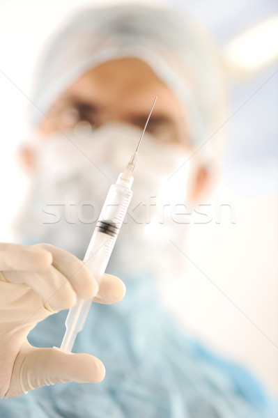 Doctor surgeon holding an injection at surgery room Stock photo © zurijeta
