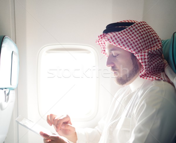 Modern Arabic businessman inside airplane Stock photo © zurijeta