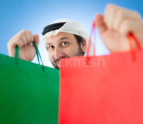 Arabic man with shopping bags smiling Stock photo © zurijeta
