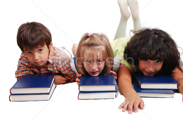 Three children laying down on books, isolated Stock photo © zurijeta