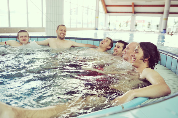 Group of friends in a swimming pool enjoying their holidays Stock photo © zurijeta