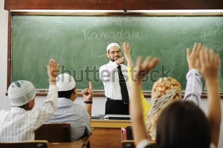 Teacher with children in classroom, boys and girls in school together learning, competition Stock photo © zurijeta