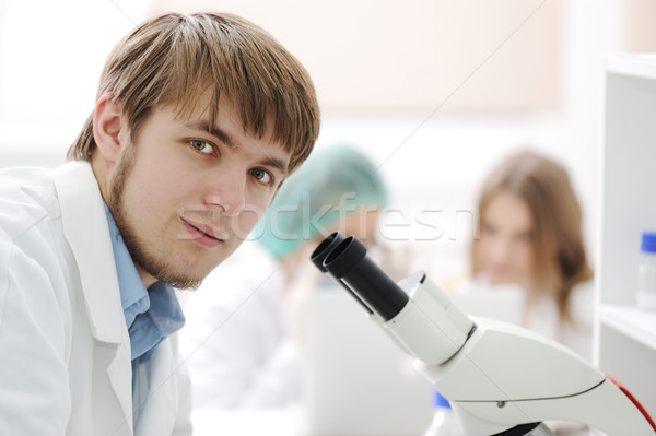 Stock photo: Team working with microscopes in a laboratory