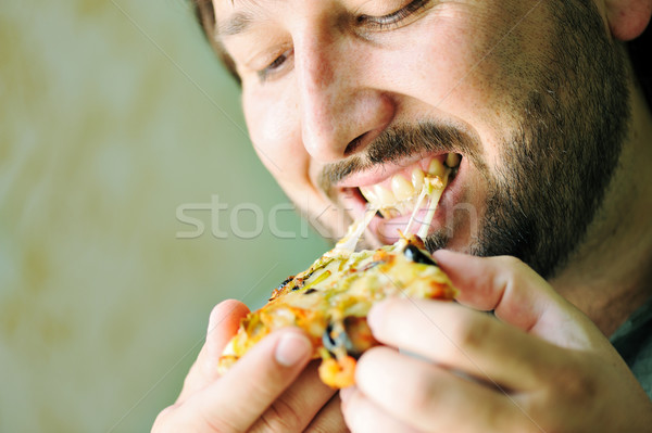 Foto stock: Moço · alimentação · pizza · comida · queijo · boca