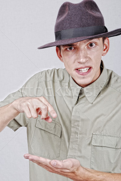 Young mane with hat is pointing with finger Stock photo © zurijeta