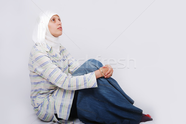 A young muslim woman in traditional clothes siting on ground Stock photo © zurijeta